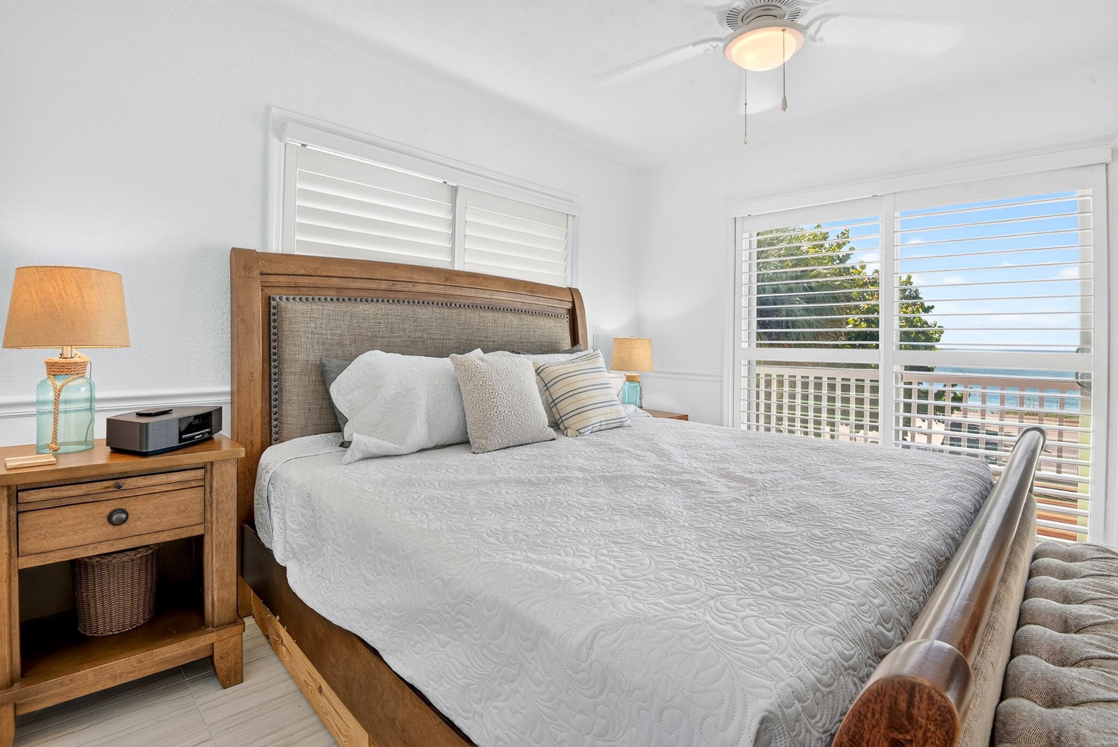 Primary bedroom with ocean-view shuttered windows