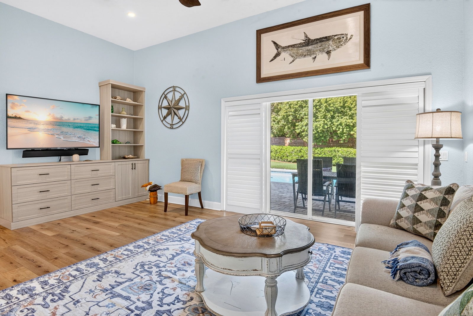 Living room with sliding doors opening to the pool patio