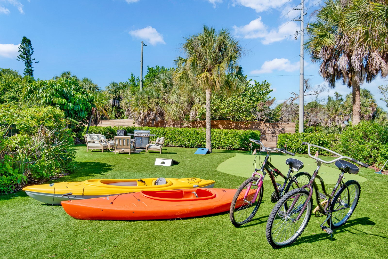 Backyard with kayaks, bicycles, and the putting green